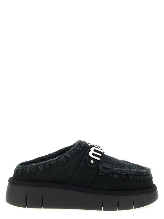 Clogs Flat Shoes by Mou for women in suede lamb leather & fur black features an statuesque silhouette from the Women's Suede Lamb Leather & Fur Clogs Flat Shoes collection, showcasing a and a statuesque for a statuesque look.