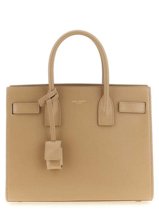 Handbag by Saint Laurent for women in calfskin leather beige features a signature silhouette, showcasing a secure and signature with versatile shoulder-strap, handle & adjustable-strap for a sophisticated look.
