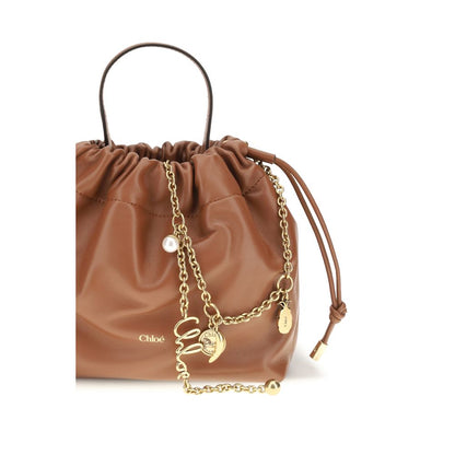 Shoulder Drawstring Bag by Chloé for women in lamb leather brown presents a statuesque silhouette, showcasing a secure drawstring and statuesque with versatile shoulder-strap & handle for a sophisticated look.