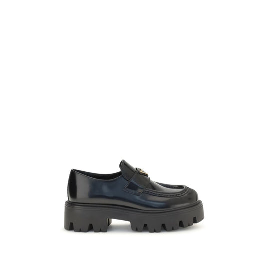 This Flat Loafer Slip-On Strap Shoes by Prada for women in bos taurus calf leather black & signature features an exquisite silhouette from the Women's Bos Taurus Calf Leather Flat Loafer Slip-On Strap Shoes collection, defined by a sophisticated flat and elegant .