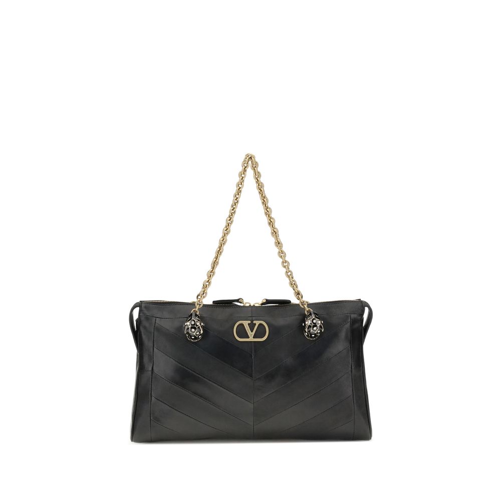Medium Shoulder Bag by Valentino Garavani for women in leather & brass black, chevron, signature & patchwork showcases a statuesque silhouette, artfully detailed with a secure zipper & button, organized , and versatile shoulder-strap & handle for a statuesque look.
