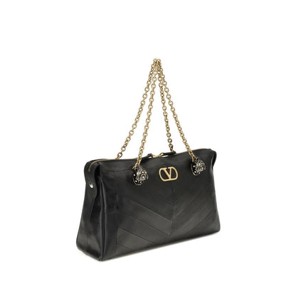 Medium Shoulder Bag by Valentino Garavani for women in leather & brass black, chevron, signature & patchwork features a statuesque silhouette, showcasing a secure zipper & button and statuesque with versatile shoulder-strap & handle for a statuesque finish.
