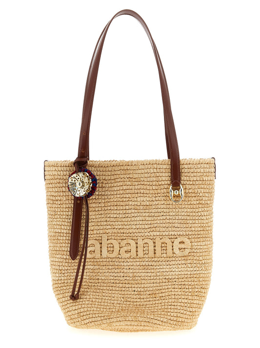 This Shopper Tote Bag by Paco Rabanne for women in raffia & calf leather beige & natural features an on trend Raffia & Calf Leather Shopper Tote Bag design with a secure , ample , and on trend adjustable-strap & handle.
