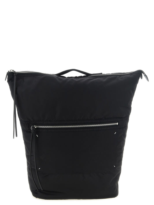 Backpack by Maison Margiela for men in polyamide black & signature showcases an architectural Four Stitches Polyamide Backpack design, featuring a secure zipper, ample external-pockets, and architectural handle & backpack-strap for a sophisticated look.