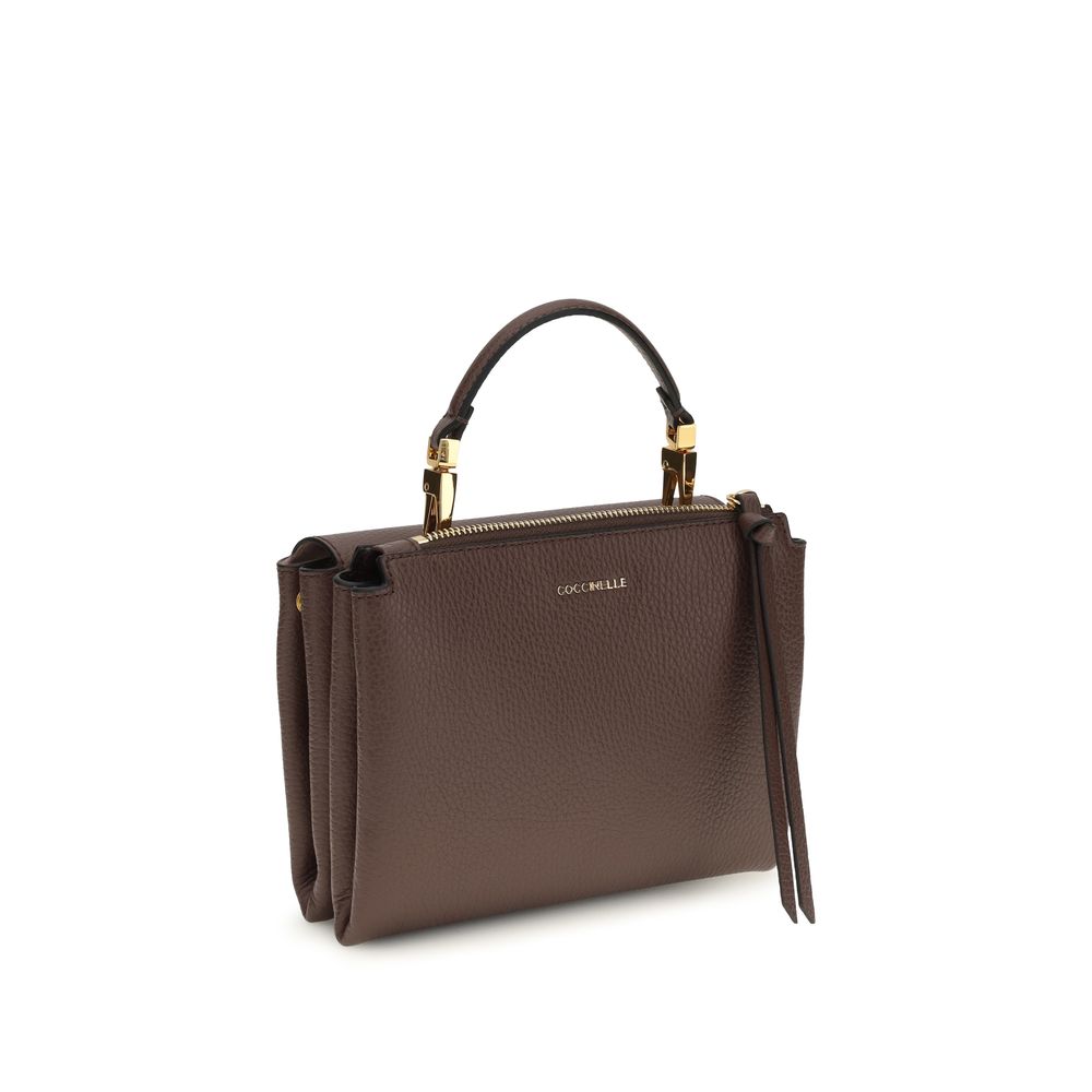 Flap Handbag by Coccinelle for women in bos taurus calfskin leather brown, gold & monogram features a signature silhouette, showcasing a secure flap & zipper and signature with versatile shoulder-strap, handle & adjustable-strap for a sophisticated look.