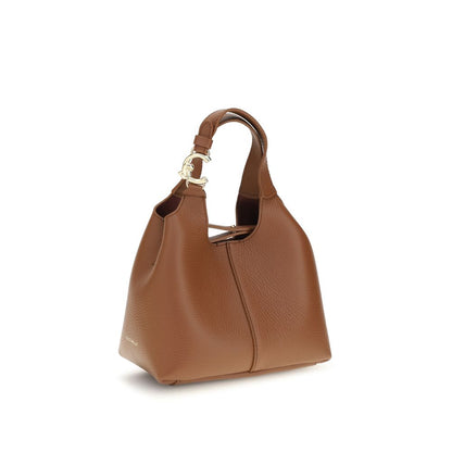Small Crossbody Pouch Handbag by Coccinelle for women in bos taurus calf grained leather brown & gold features an refined silhouette, showcasing a secure zipper & button, ample , and versatile crossbody-strap, handle, adjustable-strap & detachable-strap for a sophisticated refined aesthetic.