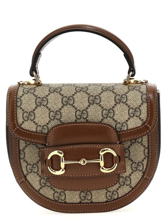 This Flap Handbag by Gucci for women in poly cotton & leather and brown & signature presents a sculptural silhouette featuring a secure flap & magnetic, ample , and versatile shoulder-strap & handle for a sculptural finish.