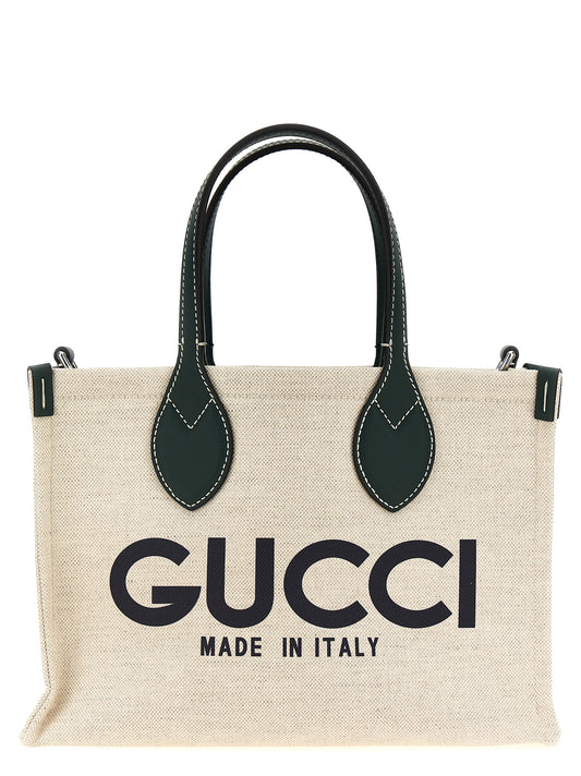Mini Shopper Tote Clutch Bag by Gucci for women in cotton polyester canvas multicolor & print features an jet-set-ready silhouette, showcasing the Cotton Polyester Canvas Mini Shopper Tote Clutch Bag design with a secure , ample , and versatile shoulder-strap, adjustable-strap & handle.