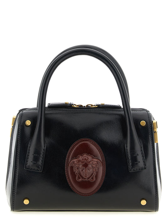 Small Handbag by Versace for women in calfskin leather black, burgundy & gold features a ornamental silhouette, showcasing a secure , ample , and ornamental shoulder-strap, handle & detachable-strap for a sophisticated look.