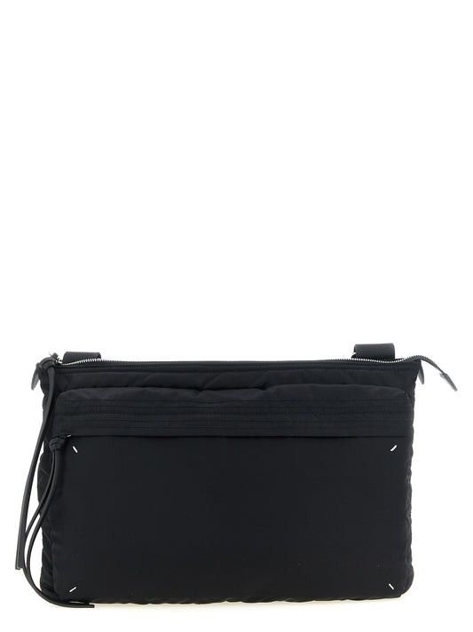 East West Crossbody Messenger Bag by Maison Margiela for men in polyamide patent leather black, silver, white & signature showcases a stylish Four Stitches Zip Computer Polyamide Patent Leather East West Crossbody Messenger Bag design, featuring a secure zipper and ample external-pockets with versatile crossbody-strap, shoulder-strap & adjustable-strap for a stylish look.