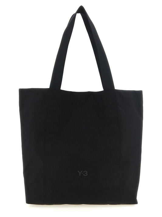 Tote Bag by Y-3 for men in coated canvas black features an jet-set Cordura Coated Canvas Tote Bag design with a secure snap & button, ample , and versatile handle for an jet-set finish.