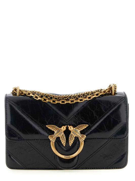 2-in-1 Shoulder & Crossbody Flap Handbag by PINKO for women in calfskin leather black, gold & chevron features an versatile silhouette, showcasing a secure flap, zipper, magnetic & buckle and versatile with versatile crossbody-strap & shoulder-strap for a versatile finish.