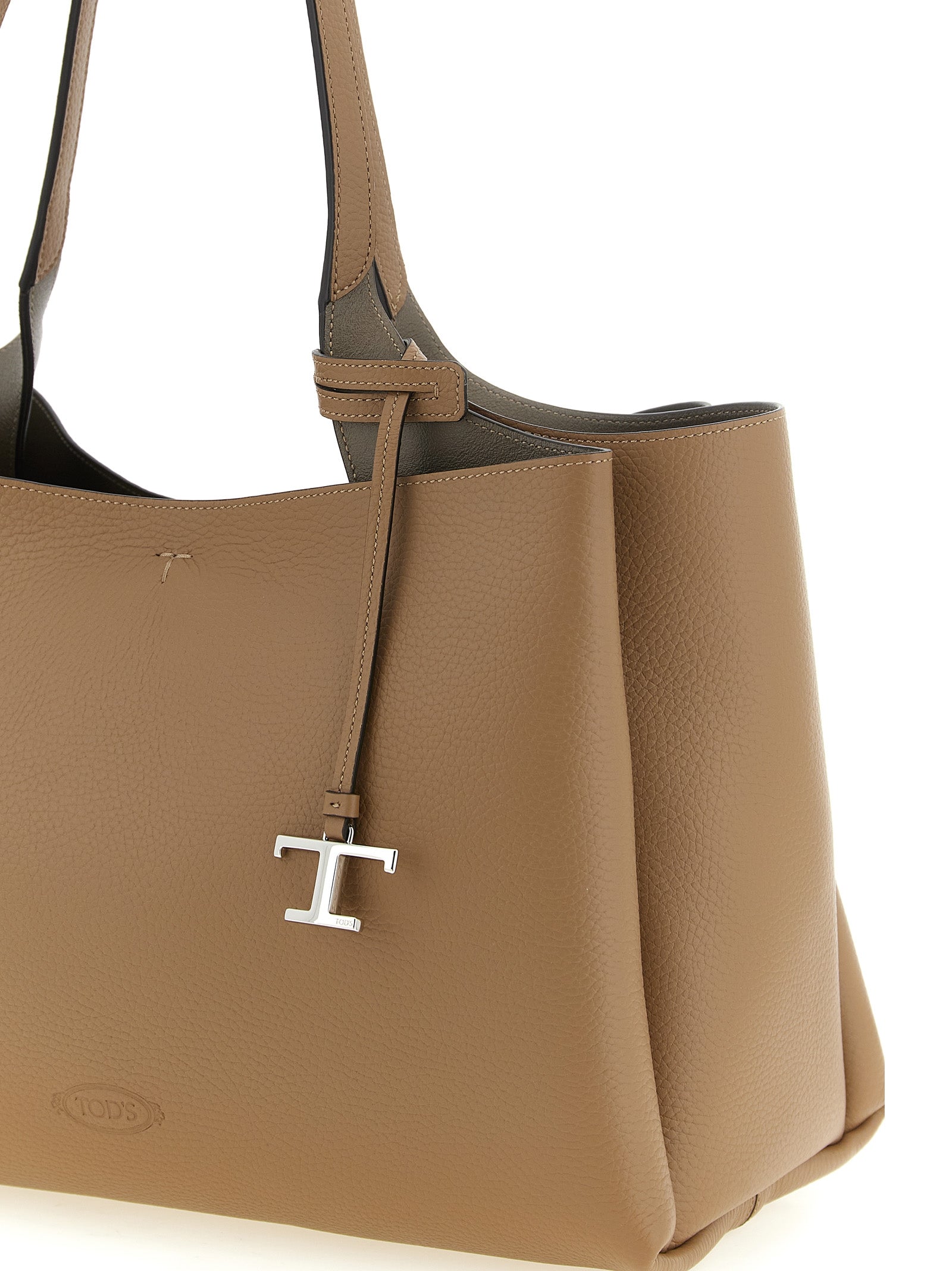 Medium Tote Bag by Tod's for women in calfskin leather brown, camel, silver & signature features a jet-set Essence T Timeless Calfskin Leather Medium Tote Bag design, complete with a secure hook, ample built-in-compartments, and versatile handle for a jet-set look.