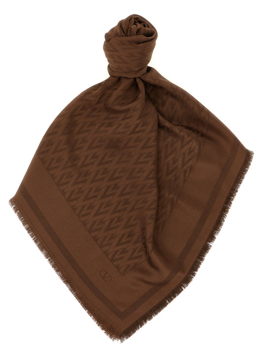 Scarf by Valentino Garavani for women in wool & silk brown, jacquard & signature presents a effortlessly chic silhouette, artfully capturing the essence of the effortlessly chic V Logo Wool & Silk Rectangular Wrap Fringes Scarf design for a sophisticated look.