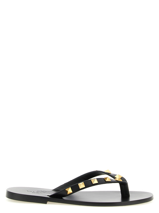 Sliders Sandals Flat Shoes by Valentino Garavani for women in calfskin leather & brass black showcases a resplendent Rockstud Women's Calfskin Leather & Brass Sliders Sandals Flat Shoes aesthetic with a and .