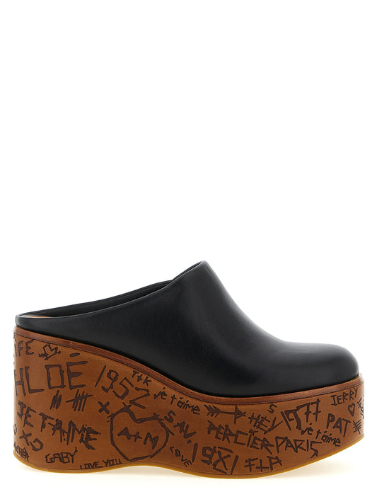 Wedge Sandals by Chloé for women in wood & calfskin leather black showcases a sculptural silhouette as Aren Women's Wood & Calfskin Leather Wedge Sandals, defined by a sculptural wedge and sculptural for a sculptural look.