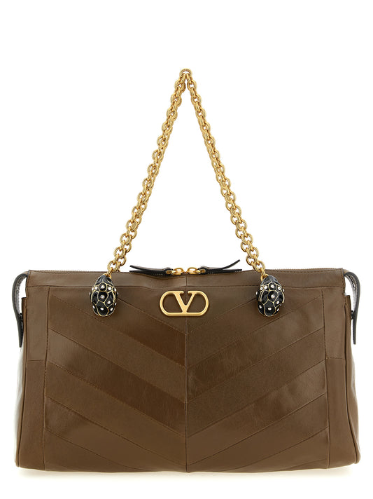 Medium Shoulder Bag by Valentino Garavani for women in exotic leather & crystal brown, gold, chevron, signature & patchwork features a enviable silhouette, showcasing a secure , ample , and enviable shoulder-strap & handle for a enviable finish.