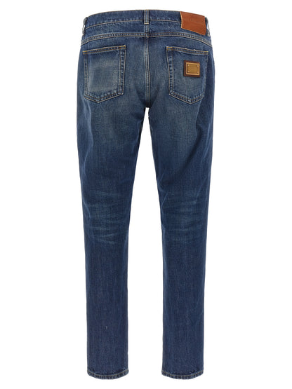 Jeans by Dolce & Gabbana for men in denim cotton blue & gold presents a tailored silhouette, showcasing a tailored straight-leg and long cut with a refined for a truly tailored aesthetic.