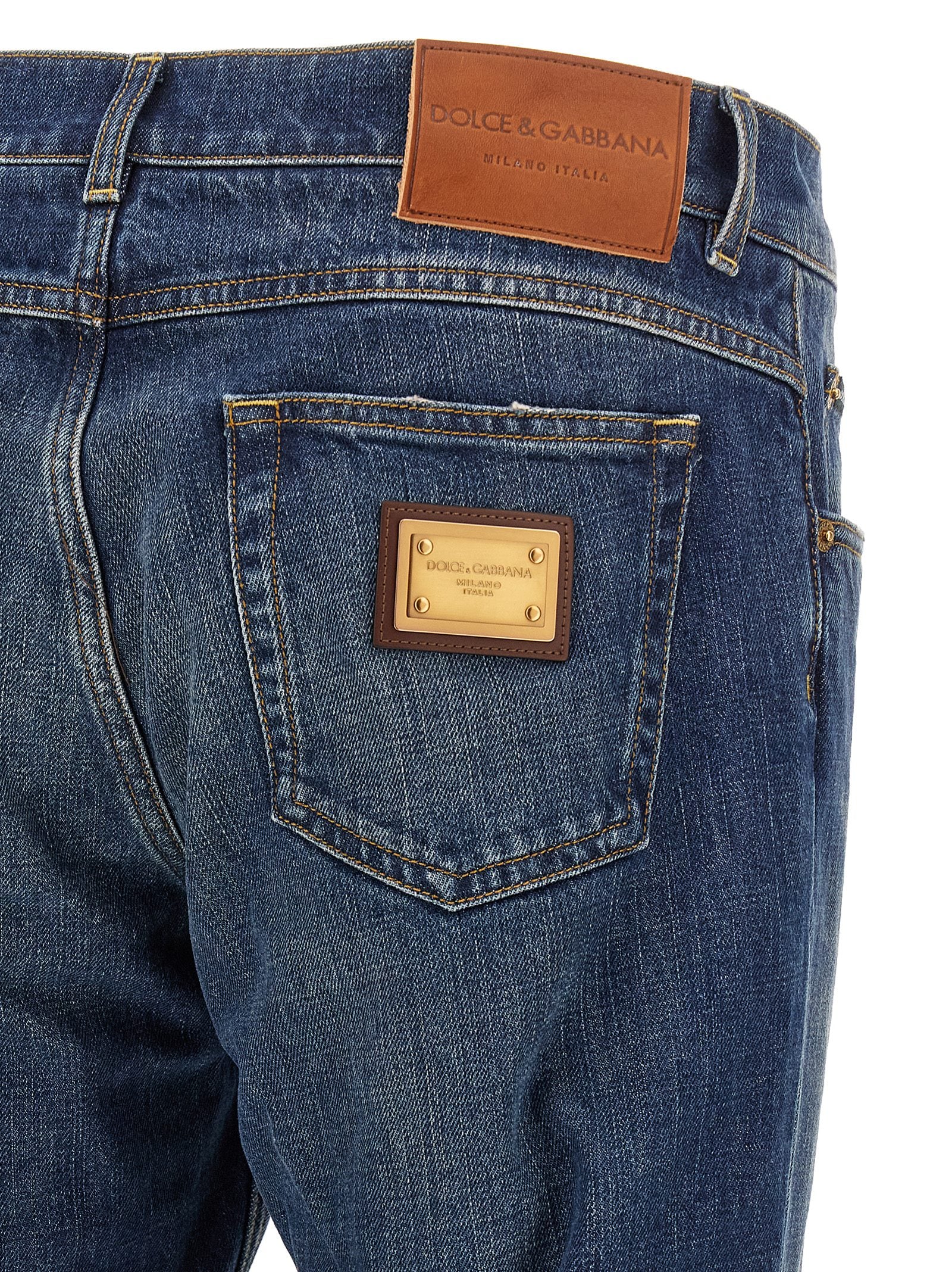 Jeans by Dolce & Gabbana for men in denim cotton blue & gold presents a tailored silhouette, showcasing a tailored straight-leg and long cut with a refined for a truly tailored aesthetic.