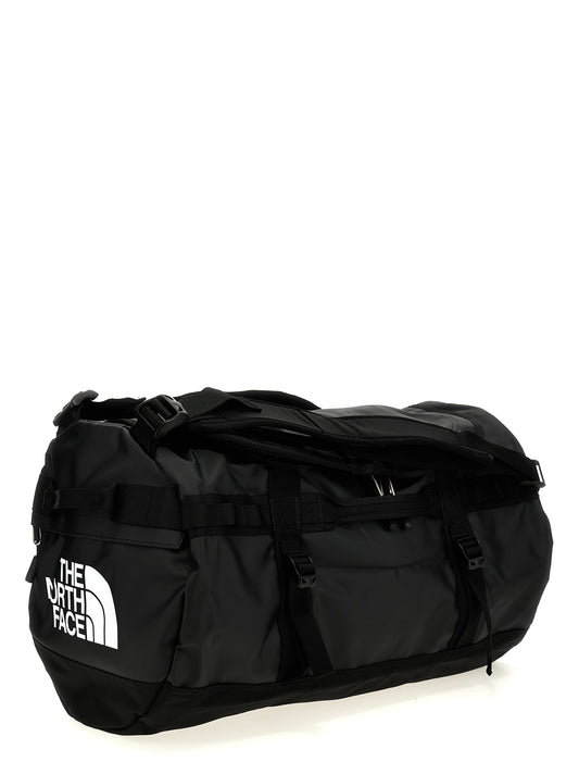 Small Travel Flap Backpack by The North Face for unisex in polyester black features a refined silhouette, showcasing the Base Camp Duffel Polyester Small Travel Flap Backpack design with a secure flap & zipper, ample , and versatile backpack-strap, adjustable-strap & handle.