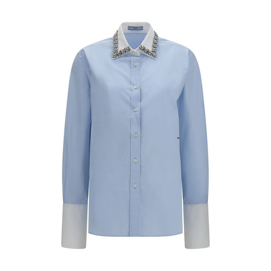 Dress Shirt by Prada for women in cotton blue showcases a sharp silhouette, elegantly detailed with a sharp and sharp long-sleeve.