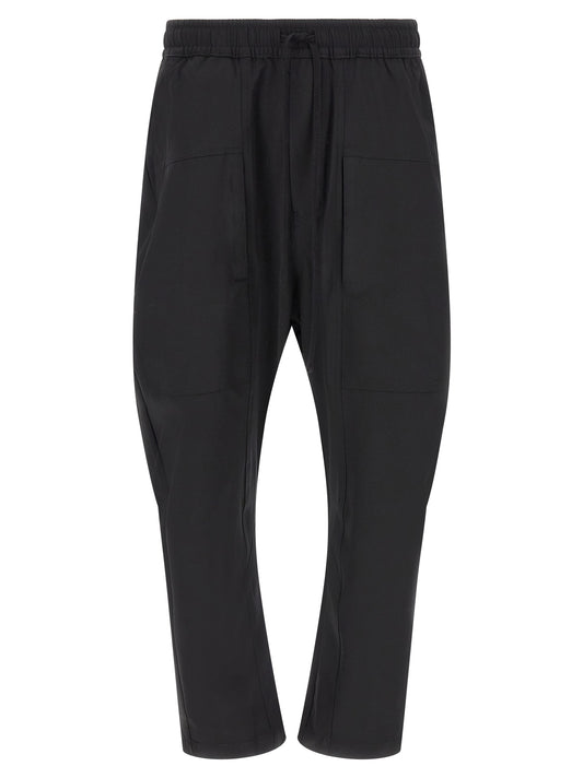 Trousers by Thom Krom for men in polyamide black presents a smart silhouette, meticulously detailed with a smart athletic & relaxed-fit, a smart long, and a smart .