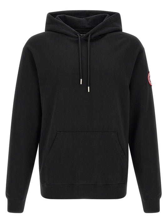 Sweatshirt Hoodie by Canada Goose for men in cotton terrycloth black features an dramatic silhouette, showcasing a sophisticated hooded neckline and dramatic for a refined, modern aesthetic.