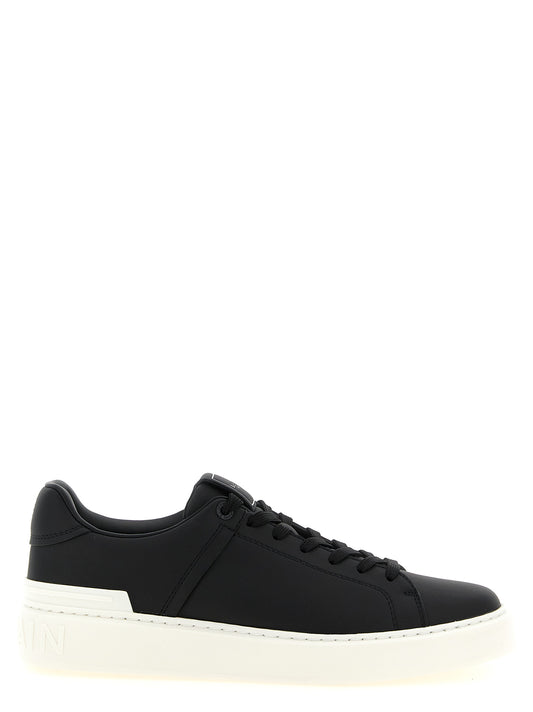 Sneakers by Balmain for men in calfskin leather bicolour, black & white presents a impeccable silhouette as Men's Low Top Calfskin Leather Sneakers, expertly defined by a impeccable low-top style for a impeccable, high-fashion look.