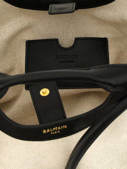 This Shopper Tote Clutch Bag by Balmain for women in linen cotton & leather bicolour, black, gold & white features an on trend Linen Cotton & Leather Shopper Tote Clutch Bag design with a secure snap, ample , and on trend handle & adjustable-strap.
