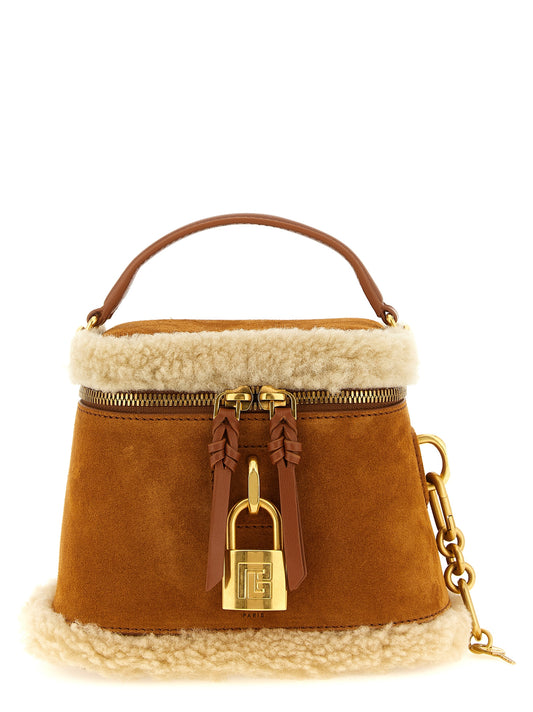 Vanity Handbag by Balmain for women in plush suede calfskin leather brown & gold presents a ornamental silhouette, showcasing a secure zipper, ample , and versatile shoulder-strap & handle for a ornamental finish.