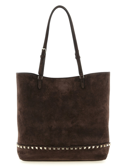 Medium Shoulder Tote Bag by Valentino Garavani for women in suede calfskin leather brown showcases a enviable silhouette, artfully detailed with a secure zipper, magnetic & buckle, organized , and versatile shoulder-strap, adjustable-strap & handle for a enviable look.
