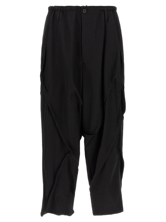 Casual Pants by Yohji Yamamoto for men in wool black presents a tailored silhouette, showcasing a tailored wide and long cut with a refined for a truly tailored aesthetic.