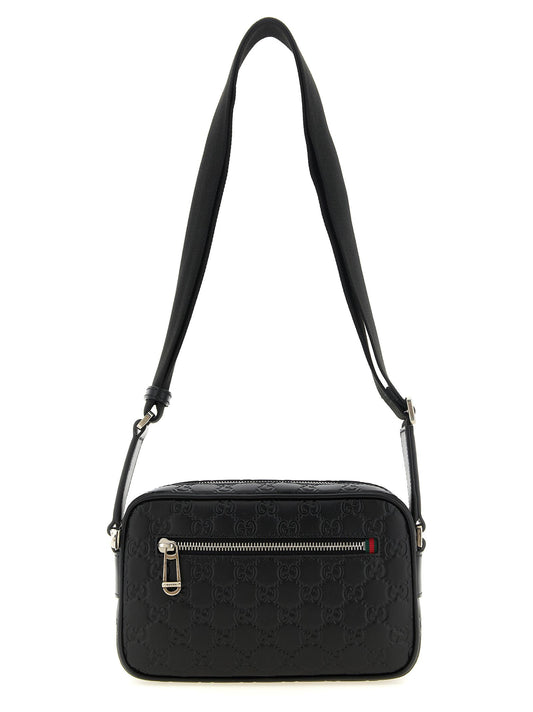 Crossbody Camera Messenger Bag by Gucci for men in linen cotton canvas & calfskin leather black, silver, patterned & monogram features a statement-making Gg Linen Cotton Canvas & Calfskin Leather Crossbody Camera Messenger Bag design with a secure zipper, statement-making external-pockets, and versatile crossbody-strap, shoulder-strap & adjustable-strap for a sophisticated look.