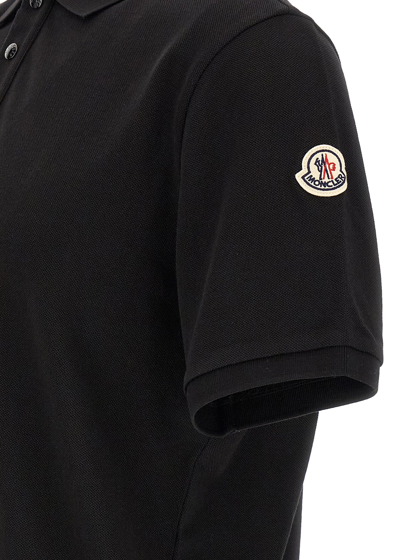 Polo Shirt by Moncler for men in cotton felt black presents a crisp silhouette, artfully detailed with a crisp and crisp .