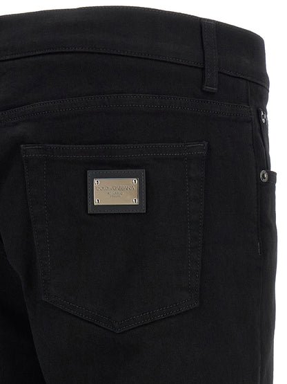 Jeans by Dolce & Gabbana for men in stretch denim cotton black features a polished silhouette with a polished slim, reaching a polished long and finished with a polished .