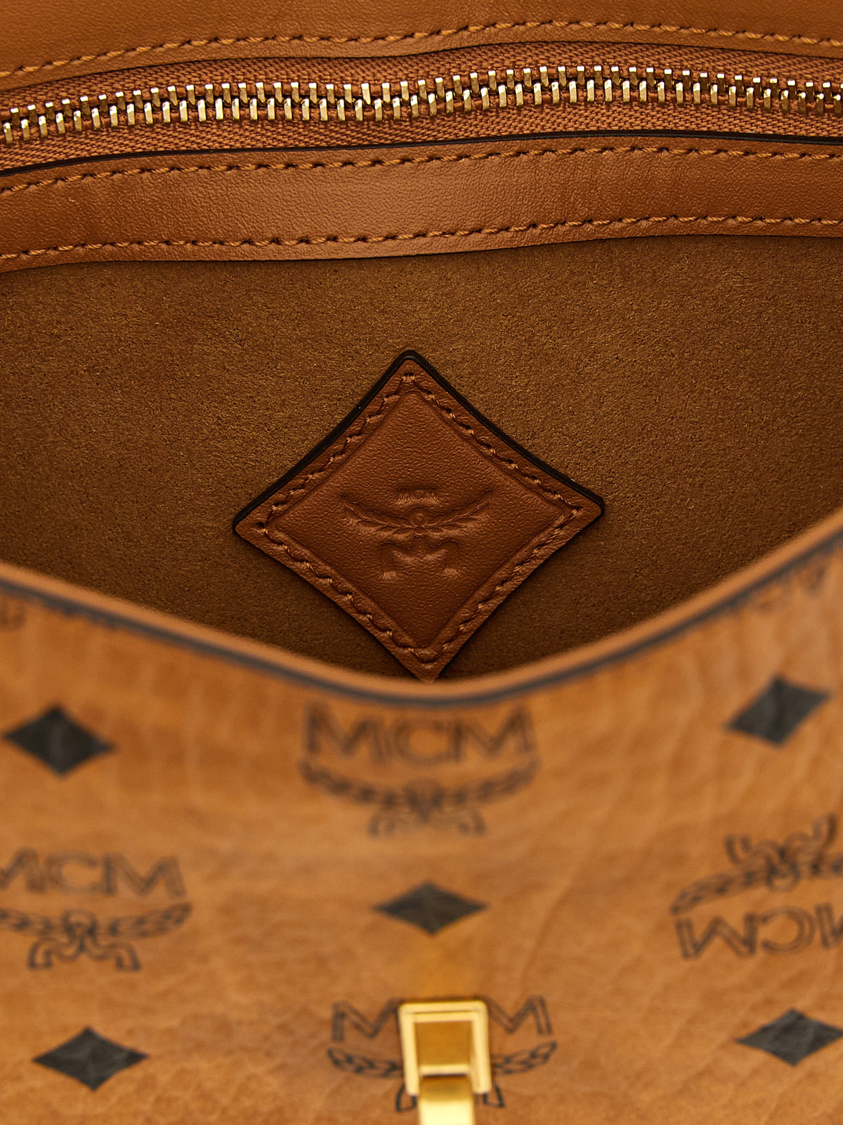 Shoulder Bag by MCM for women in polyester polyurethane cotton & suede leather brown, gold & monogram presents a versatile silhouette, showcasing a secure zipper & turn-lock and versatile with versatile shoulder-strap & adjustable-strap for a sophisticated look.