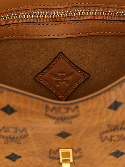 Shoulder Bag by MCM for women in polyester polyurethane cotton & suede leather brown, gold & monogram presents a versatile silhouette, showcasing a secure zipper & turn-lock and versatile with versatile shoulder-strap & adjustable-strap for a sophisticated look.