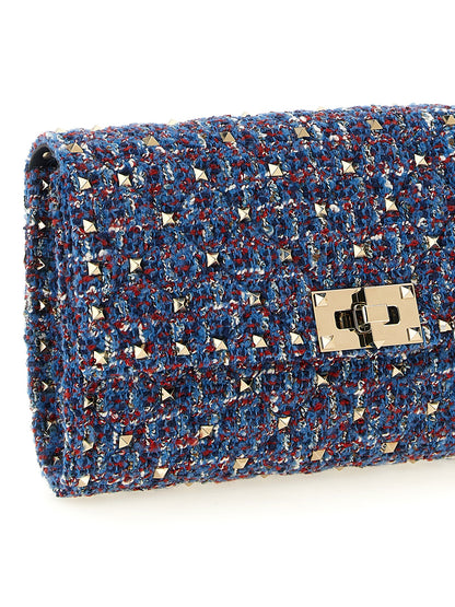 2-in-1 Shoulder & Crossbody Handbag by Valentino Garavani for women in cotton tweed leather & virgin wool blue features a transformative elegance silhouette, showcasing a secure zipper, organized , and versatile crossbody-strap & shoulder-strap for a transformative elegance look.