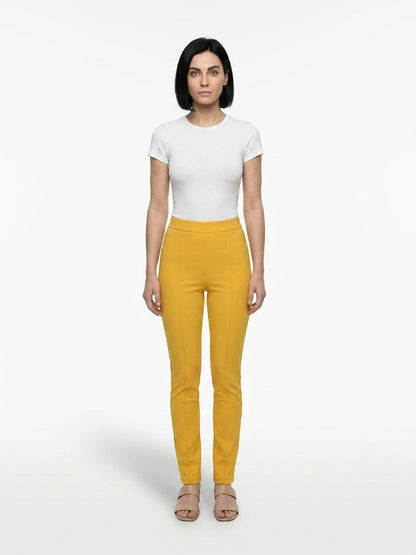 Trousers by Dolce & Gabbana for women in stretch polyester yellow features a tailored silhouette with a tailored skinny, defined by its long and a sophisticated .
