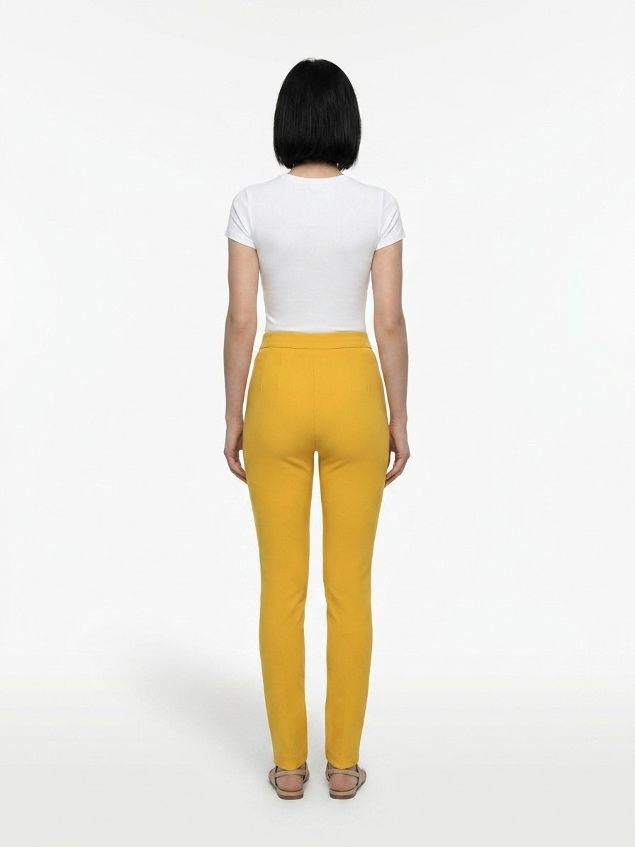 Trousers by Dolce & Gabbana for women in stretch polyester yellow features a sculptural silhouette, showcasing a sculptural skinny and long with a sophisticated for a sculptural finish.