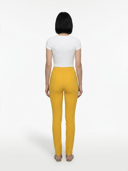 Trousers by Dolce & Gabbana for women in stretch polyester yellow features a sculptural silhouette, showcasing a sculptural skinny and long with a sophisticated for a sculptural finish.