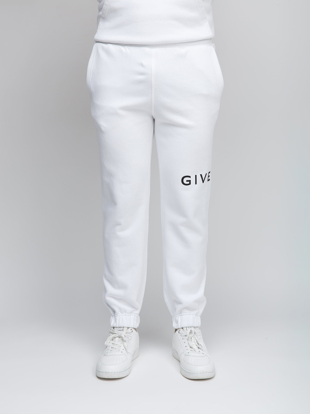 Joggers by Givenchy for men in cotton white features a polished silhouette with a polished slim, reaching a polished long and finished with a polished .