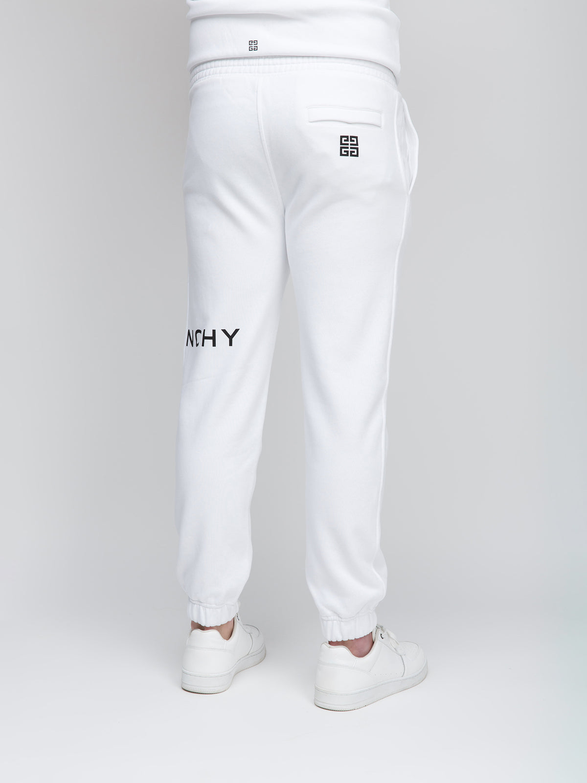 Joggers by Givenchy for men in cotton white presents a refined pantology silhouette, artfully defined by a refined pantology slim, long, and a sophisticated .