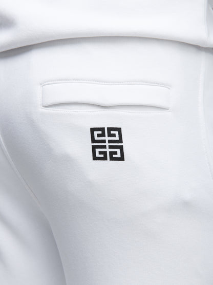 Joggers by Givenchy for men in cotton white features a polished silhouette with a polished slim, reaching a polished long and finished with a polished .
