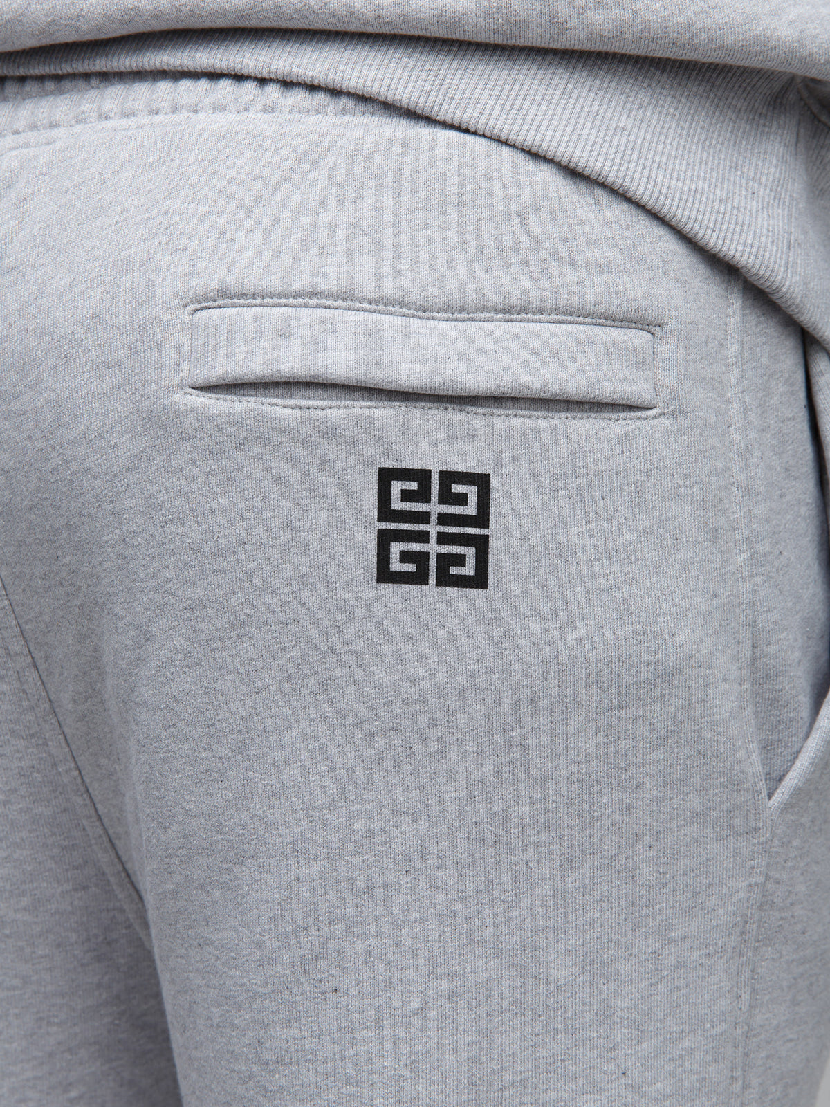 Joggers by Givenchy for men in cotton gray features a refined silhouette with a refined slim, defined by a and a refined long for a refined finish.
