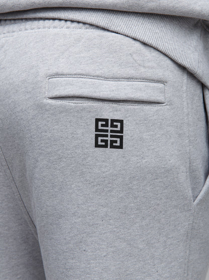Joggers by Givenchy for men in cotton gray features a refined silhouette with a refined slim, defined by a and a refined long for a refined finish.