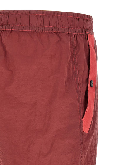 Joggers by Stone Island for men in nylon red presents a refined pantology silhouette, artfully defined by a refined pantology regular-fit, long, and a sophisticated .