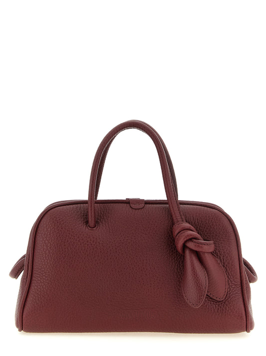 Bowling Handbag by Jacquemus for women in calfskin leather bordeaux & silver features a contemporary silhouette, showcasing a secure zipper, ample , and contemporary handle & adjustable-strap for a sophisticated look.