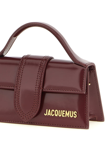 Handbag by Jacquemus for women in patent calfskin leather bordeaux & gold features a contemporary silhouette, showcasing a secure , ample , and contemporary shoulder-strap & handle for a sophisticated look.