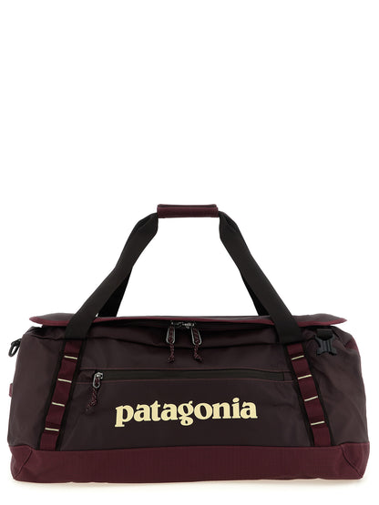 Travel Backpack by PATAGONIA for men in tu & polyester black & bordeaux features a fashionable silhouette, showcasing the Black Hole TU & Polyester Travel Backpack design with a secure , ample , and versatile backpack-strap, adjustable-strap & handle.